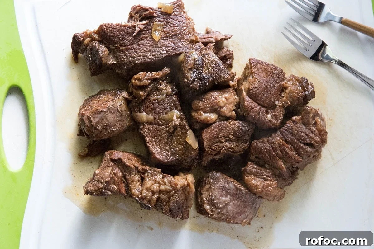 Instant Pot Vietnamese-Style Shredded Beef Recipe 7 Chunks of beef on a cutting board waiting to be shredded