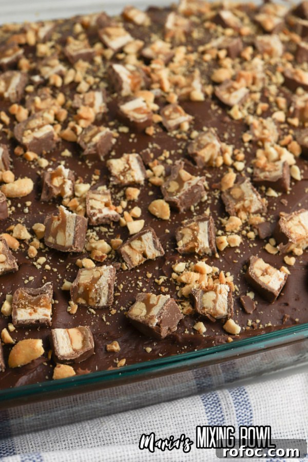 Decadent Snickers Poke Cake: Gooey Chocolate-Caramel Dessert 5 Snickers poke cake in baking dish