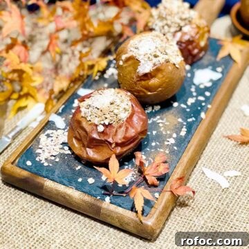 Baked apples with oatmeal on a blackboard