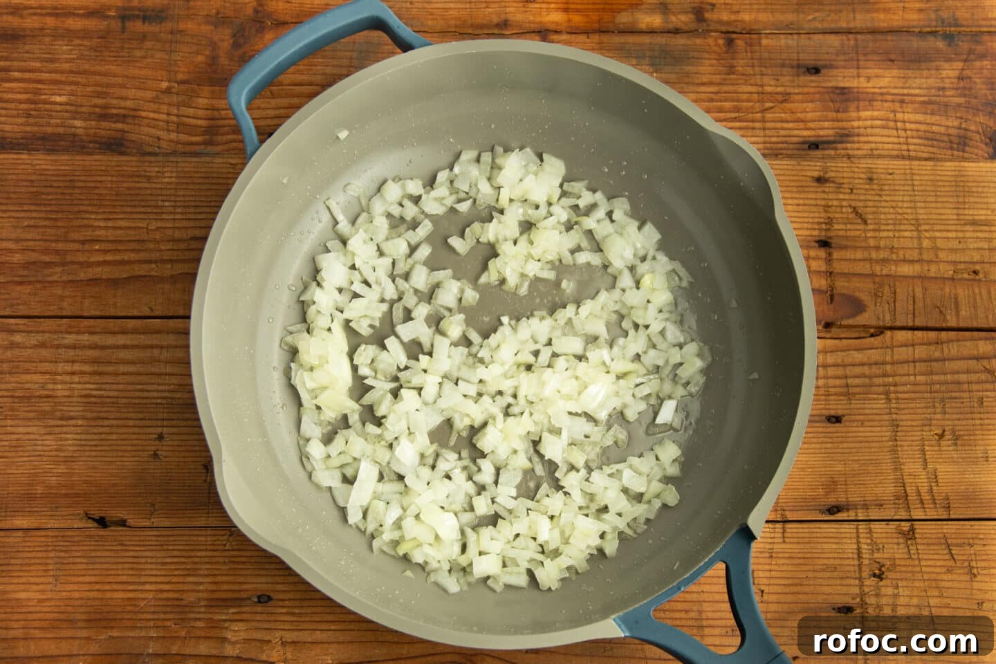 This is a picture of a skillet with onion cooking.