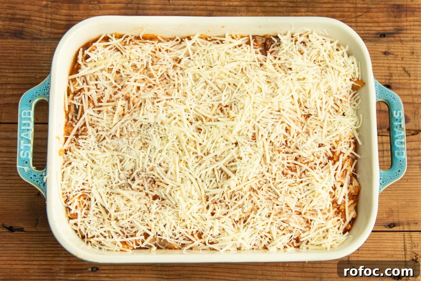 This is a picture of the baking dish with the chicken and squash mixture topped with cheese.