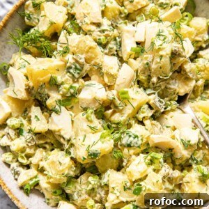 Creamy Dill Potato Salad with Fresh Herbs and Lemon Zest 8 top down view of potato salad with dill and green onions