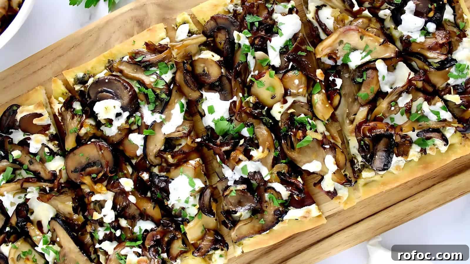 23 Vegetarian Dinners That Even Meat Eaters Will Love 22 Flatbread topped with mushrooms, cheese, herbs, and sauce, served on a wooden board.