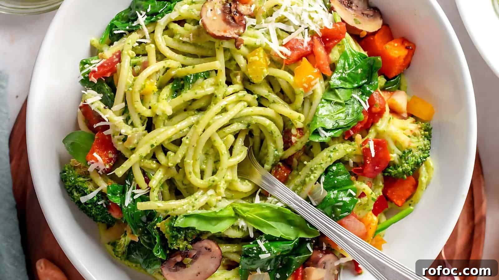23 Vegetarian Dinners That Even Meat Eaters Will Love 8 Bowl of pasta with pesto sauce, tomatoes, spinach, broccoli, mushrooms, and grated cheese. Spoon on the side.