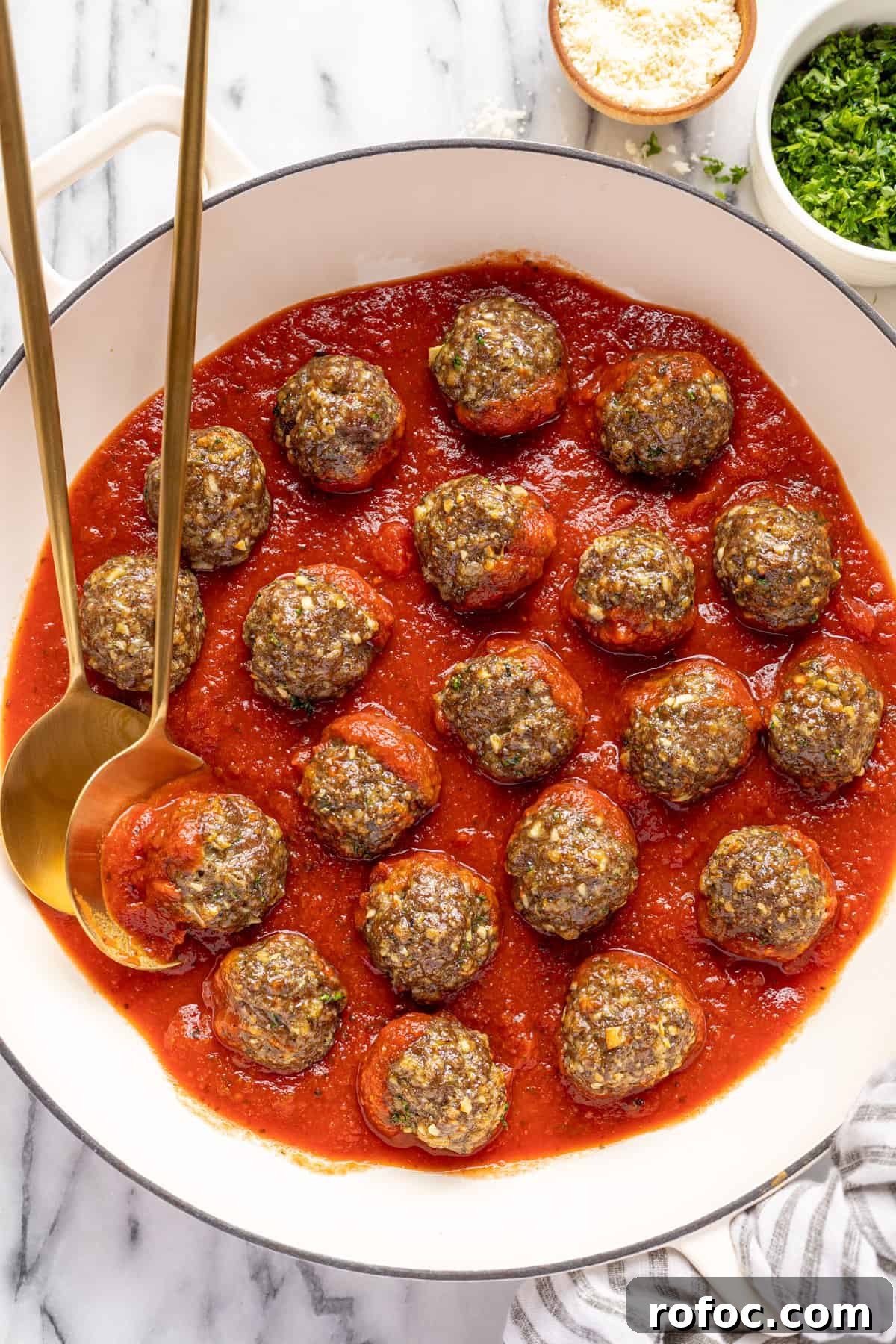 Authentic Italian Meatballs Recipe Ready in 30 Minutes 9 Large white pan filled with red sauce and homemade baked meatballs.