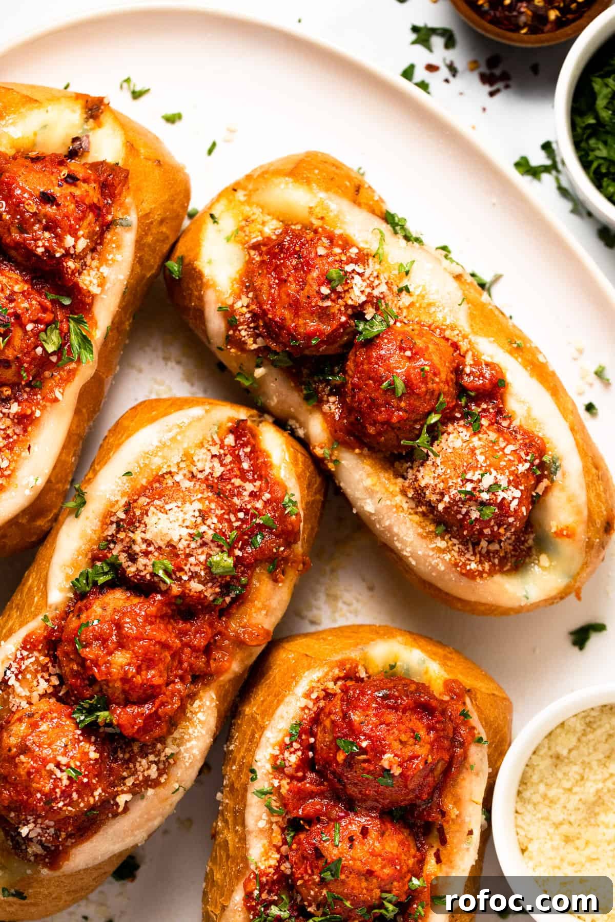 Authentic Italian Meatballs Recipe Ready in 30 Minutes 12 Meatball sub sandwiches on a large white platter.