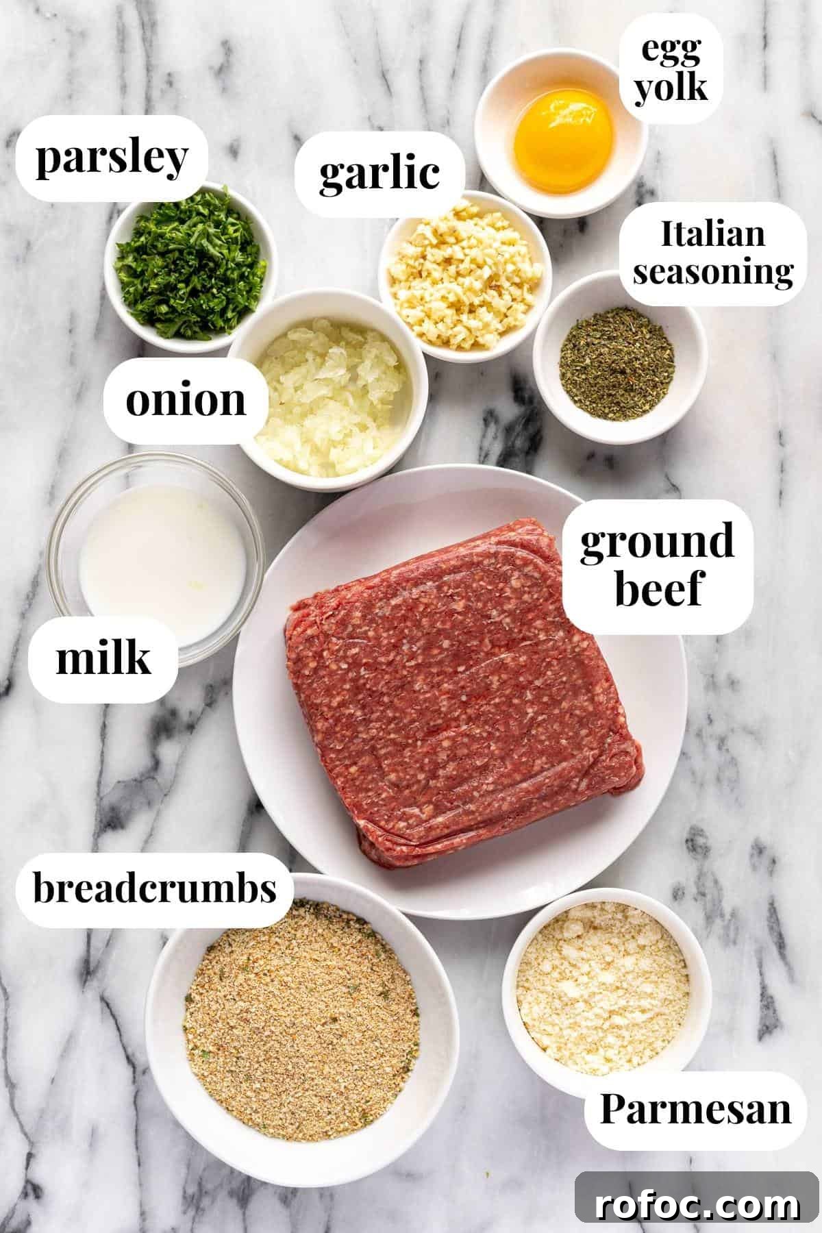 Authentic Italian Meatballs Recipe Ready in 30 Minutes 3 White marble counter top with bowls of ingredients to make homemade Italian baked meatballs.