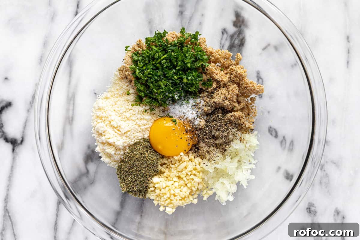 Authentic Italian Meatballs Recipe Ready in 30 Minutes 5 Glass bowl filled with ingredients to make Italian meatballs.