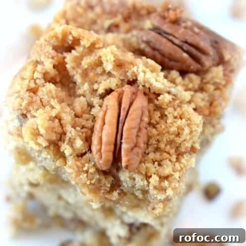 Moist Banana Crumb Cake Recipe with Cinnamon Streusel 6 A close up of a piece of cake on a plate, with Banana