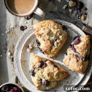 Fresh Cherry Scones: Flaky Homemade Recipe for Summer Baking 14 Three cherry scones on a tray with a cup of coffee.