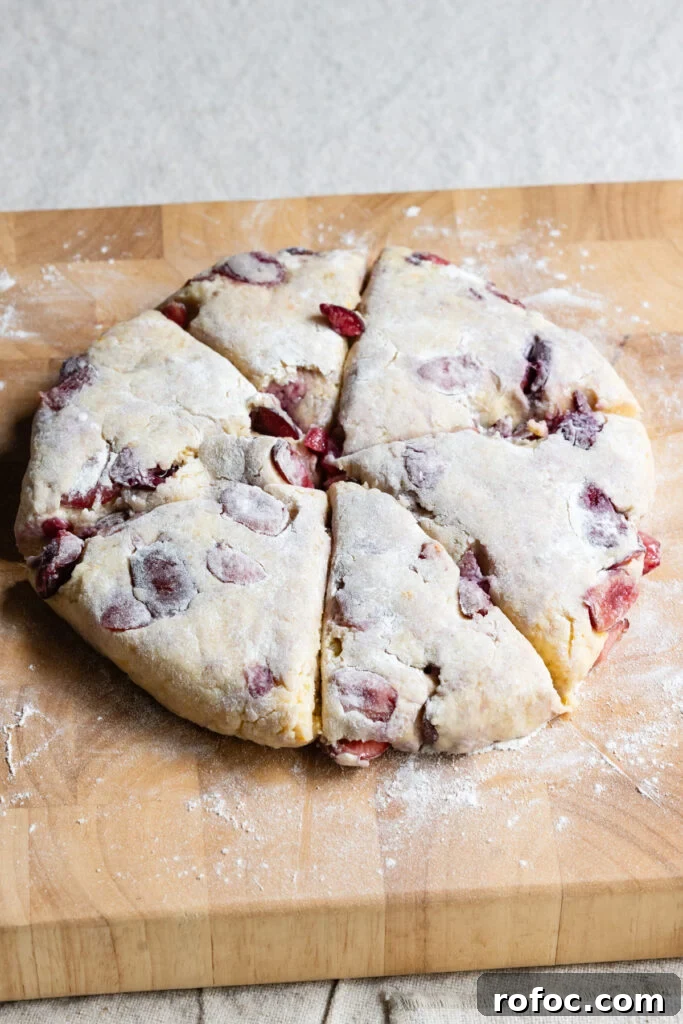 Fresh Cherry Scones: Flaky Homemade Recipe for Summer Baking 9 Circle of scone dough with triangle slices.