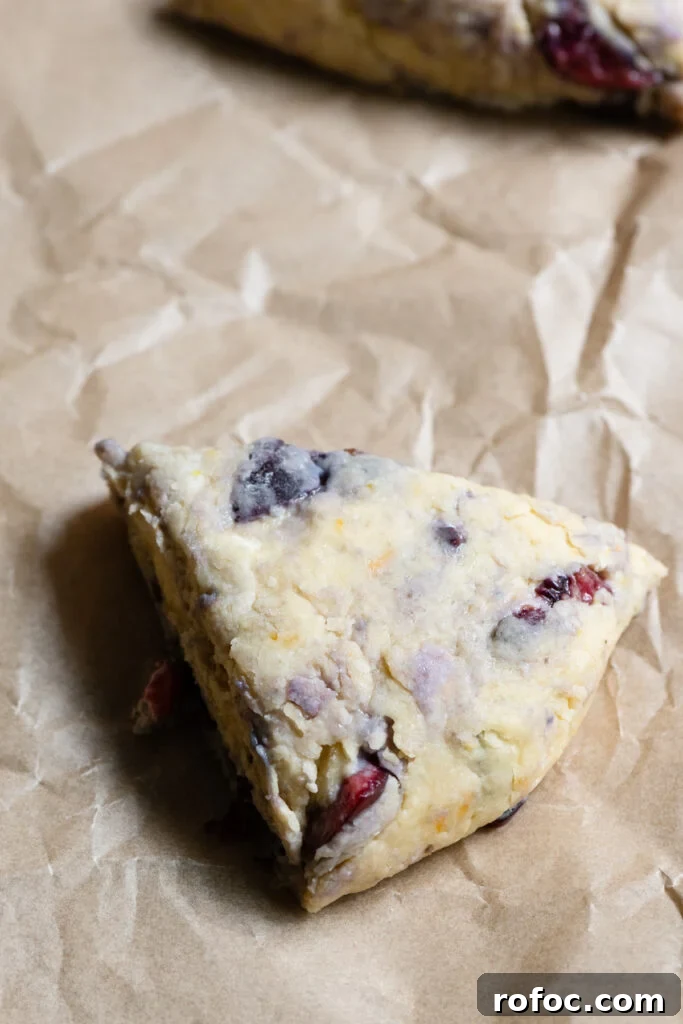 Fresh Cherry Scones: Flaky Homemade Recipe for Summer Baking 10 Unbaked triangle of cherry scone dough on parchment paper.