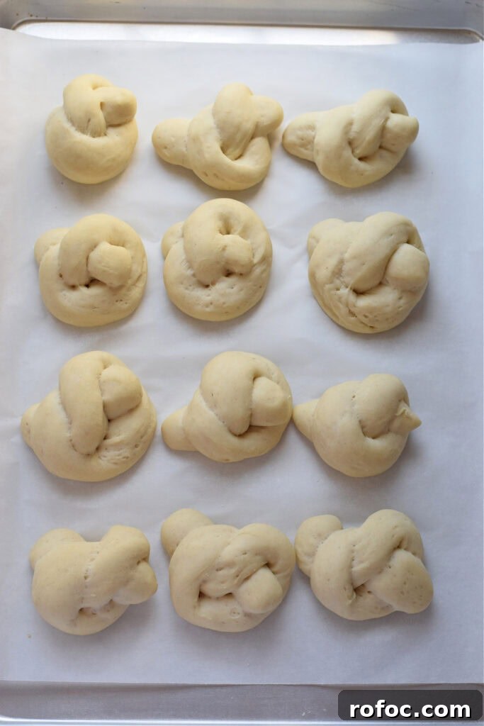 How to Make Homemade Garlic Knots: Soft, Chewy & Flavorful 11 Garlic knots on a baking tray.
