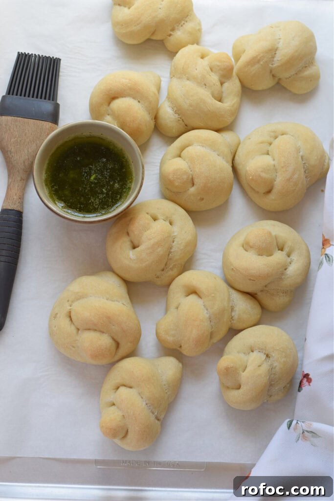 How to Make Homemade Garlic Knots: Soft, Chewy & Flavorful 12 Baked garlic knots on a tray.