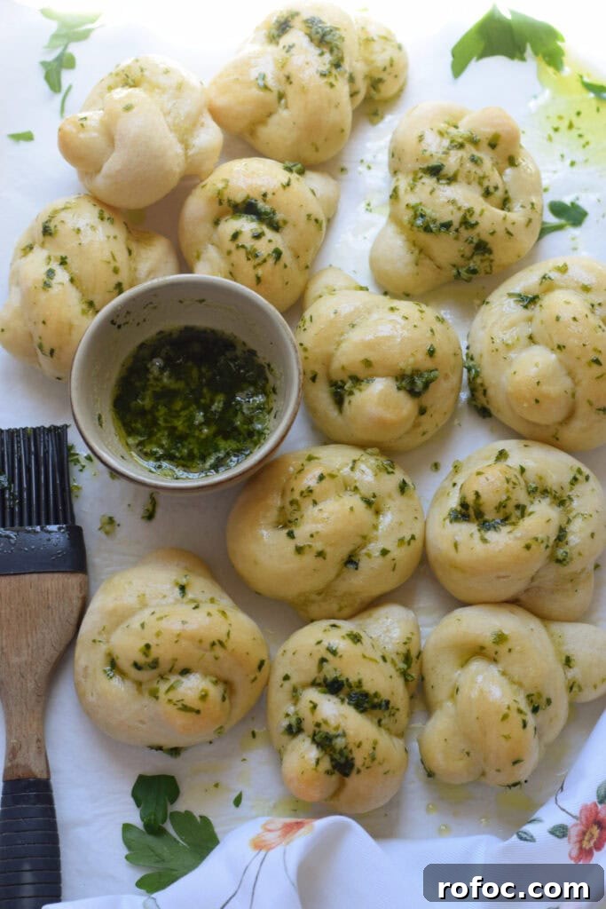 How to Make Homemade Garlic Knots: Soft, Chewy & Flavorful 3 Homemade garlic knots on a tray.