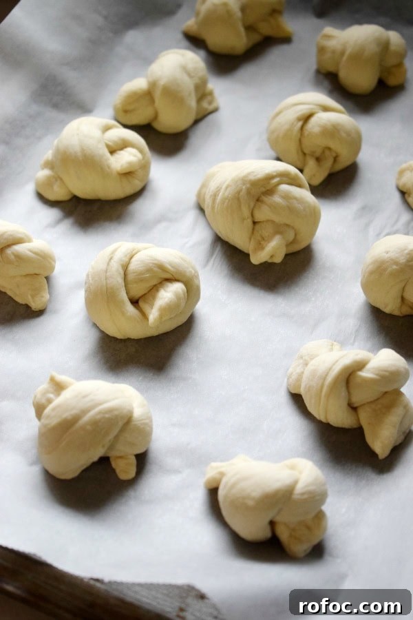 How to Make Homemade Garlic Knots: Soft, Chewy & Flavorful 10 Garlic knots on a baking tray.
