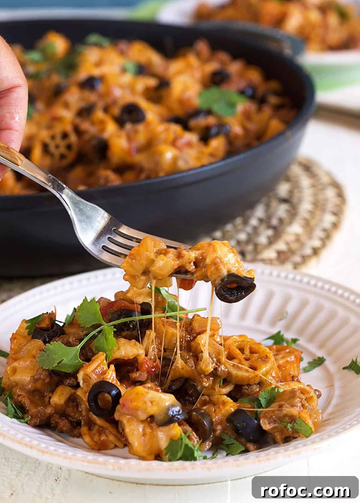 Cheesy Taco Pasta Recipe: One-Pot Mexican-Inspired Dinner 5 Taco pasta on a white plate with a fork