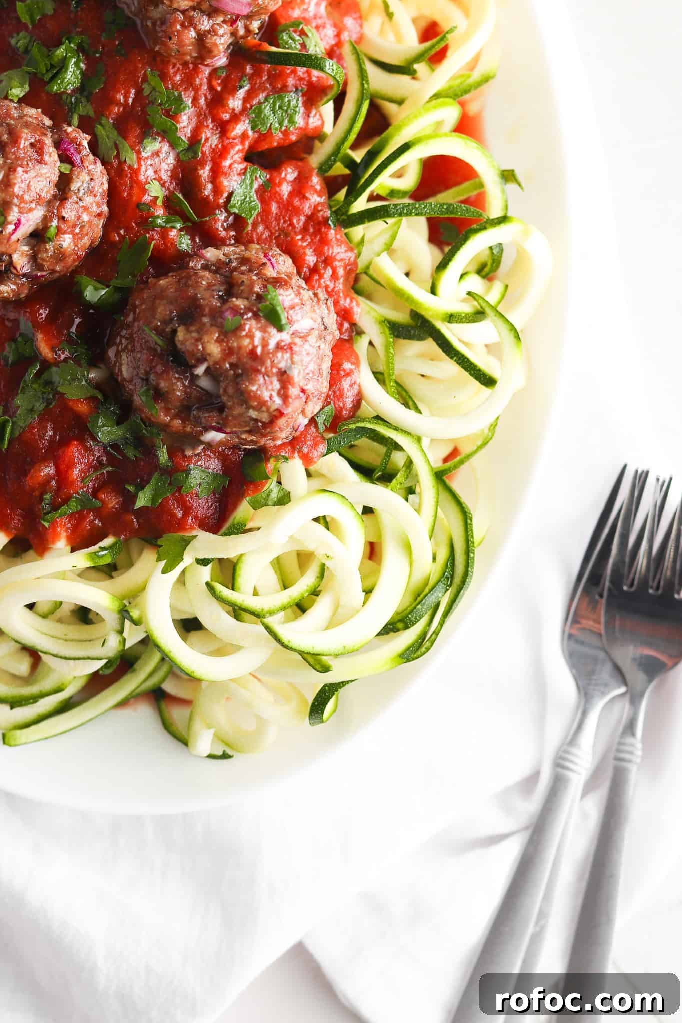Gluten-Free Meatballs: Savory, Tender Recipe for Dinner 9 Spaghetti and gluten free meatballs on a white plate with forks.
