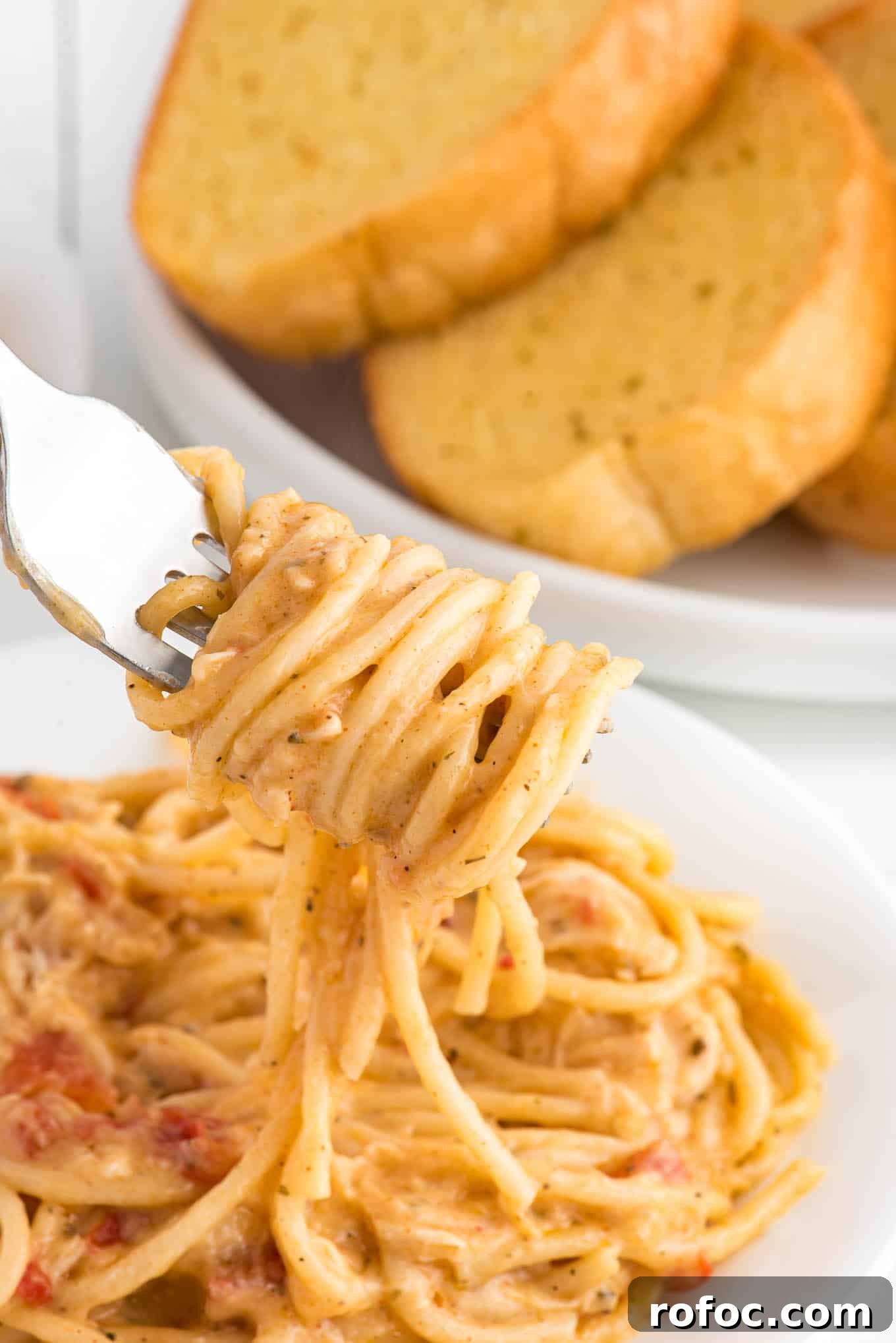 Slow-Cooker Chicken Spaghetti Recipe for Creamy, Cheesy Comfort 2 Plate of crockpot chicken spaghetti on a plate.
