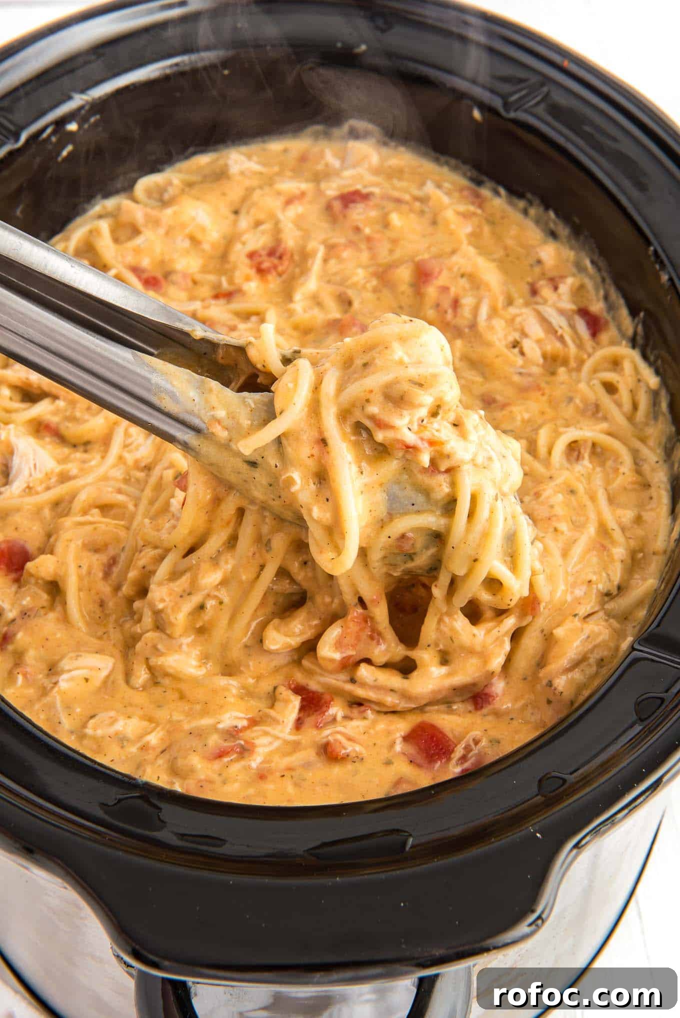 Slow-Cooker Chicken Spaghetti Recipe for Creamy, Cheesy Comfort 9 Crockpot with prepared chicken spaghetti.