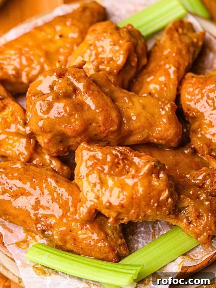 memphis honey gold wings on a plate with celery.