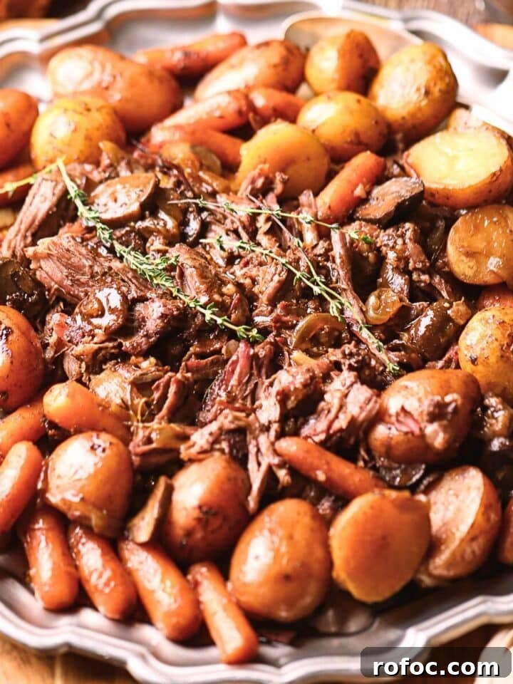 Ultimate Dutch oven pot roast with vegetables on a serving platter.
