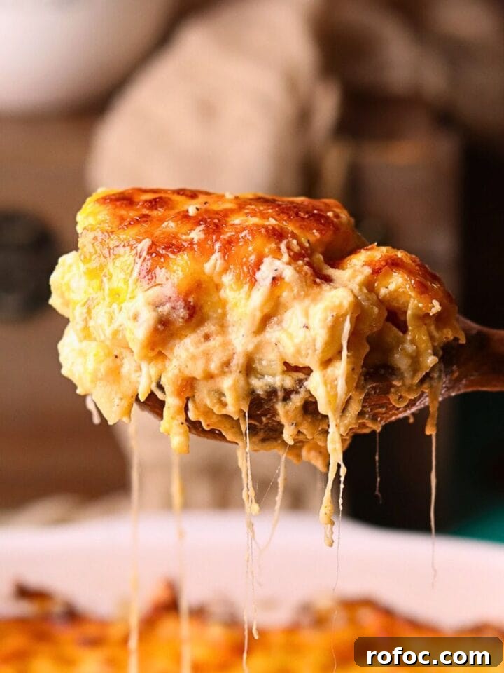 A serving of creamy southern baked mac & cheese on a serving spoon.