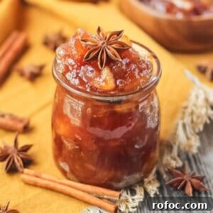 How to Make Classic Homemade Apple Jam: Simple Step-by-Step Recipe 19 apple jam in a glass jar sitting on a wooden surface.