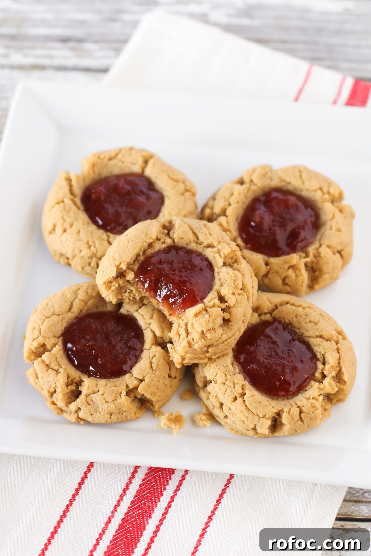 Gluten free vegan peanut butter and jelly thumbprint cookies. Soft peanut butter cookies, filled with your favorite berry jam. The classic combo in a cookie!