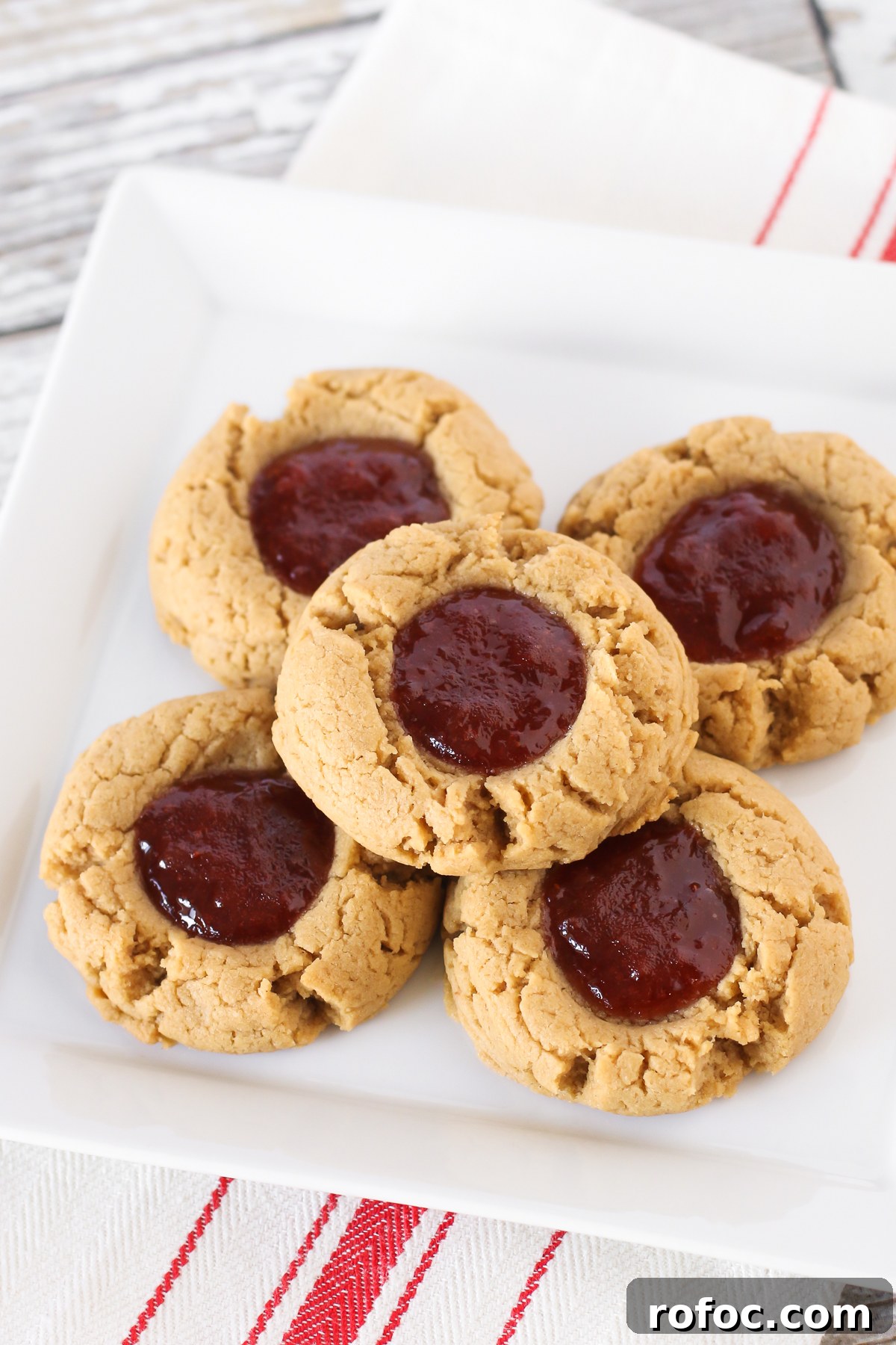 Gluten free vegan peanut butter and jelly thumbprint cookies. Soft peanut butter cookies, filled with your favorite berry jam. The classic combo in a cookie!