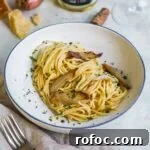 Miso Pasta with Sweet Caramelized Shallots and Toasted Sesame 12 Miso spaghetti with caramelized shallots, Italian flat-leaf parlsey, and Parmigiano-Reggiano in a shallow pasta bowl.