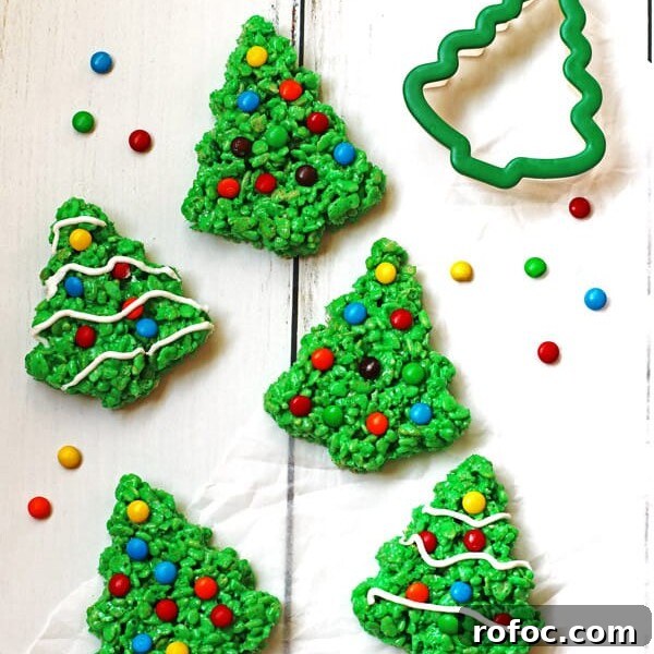 Magical Elf Donuts: Festive Donut Recipes & Decorating Ideas 13 Green Rice Krispie Trees decorated with M&M candy and white icing.