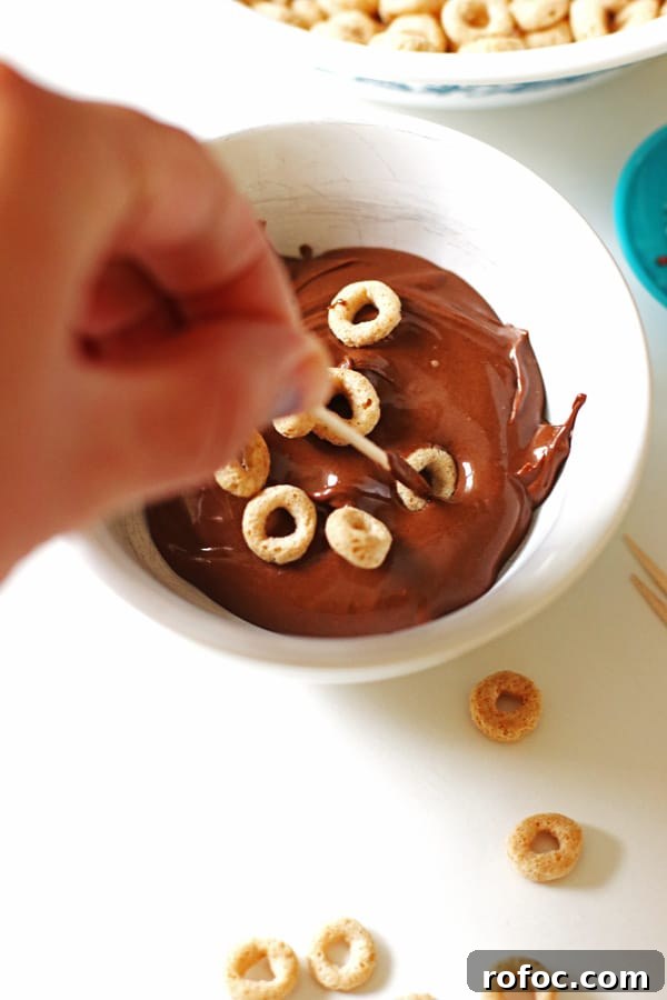 Magical Elf Donuts: Festive Donut Recipes & Decorating Ideas 6 Dipping Cheerios into melted chocolate with a toothpick
