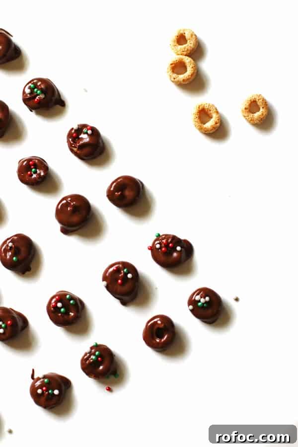 Magical Elf Donuts: Festive Donut Recipes & Decorating Ideas 7 Chocolate covered Cheerios with red and green sprinkles on white parchment paper