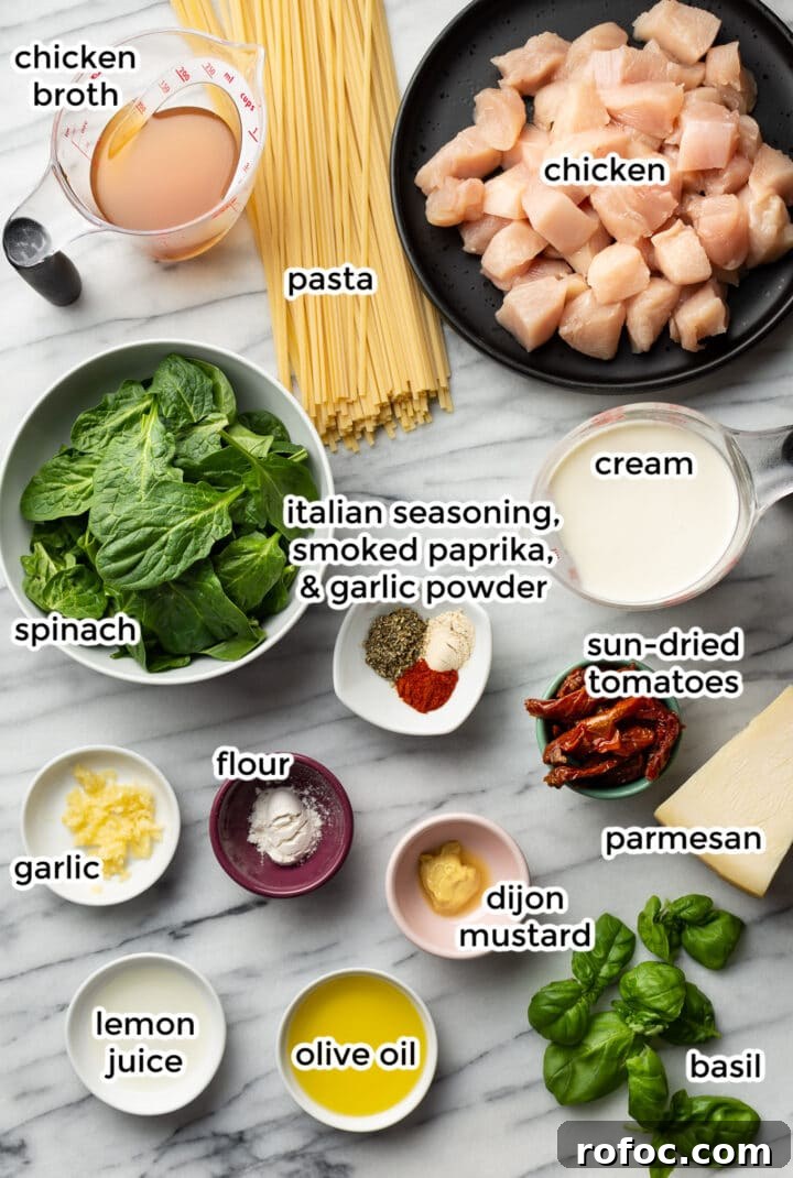Creamy Tuscan Chicken Pasta: Garlic Parmesan Skillet Recipe 3 all the ingredients for creamy tuscan chicken pasta in small bowls and plates on a marble surface