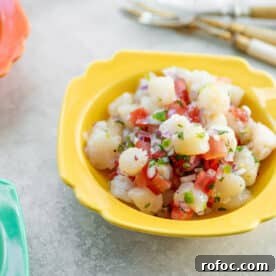 Scallop ceviche in yellow bowl.