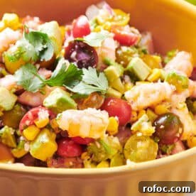 Salad with shrimp and avocado in yellow serving bowl.