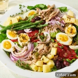 Nicoise Salad with asparagus, eggs, and red onions.