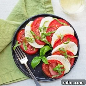 Tomato and Mozzarella Caprese Salad on black plate.