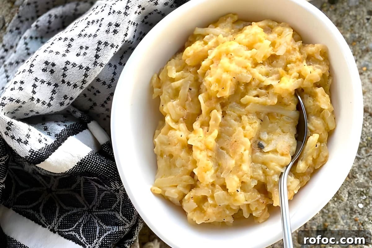 12 Delicious Easter Crockpot Recipes for a Stress-Free Holiday 8 Cheesy hashbrown casserole in a serving dish.