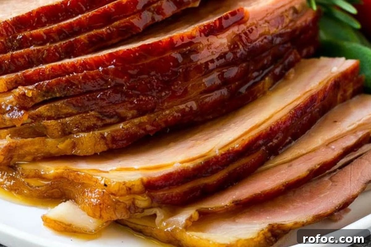 12 Delicious Easter Crockpot Recipes for a Stress-Free Holiday 9 Close-up of beautifully sliced glazed ham with caramelized edges, showcasing a golden brown sheen and tender texture.