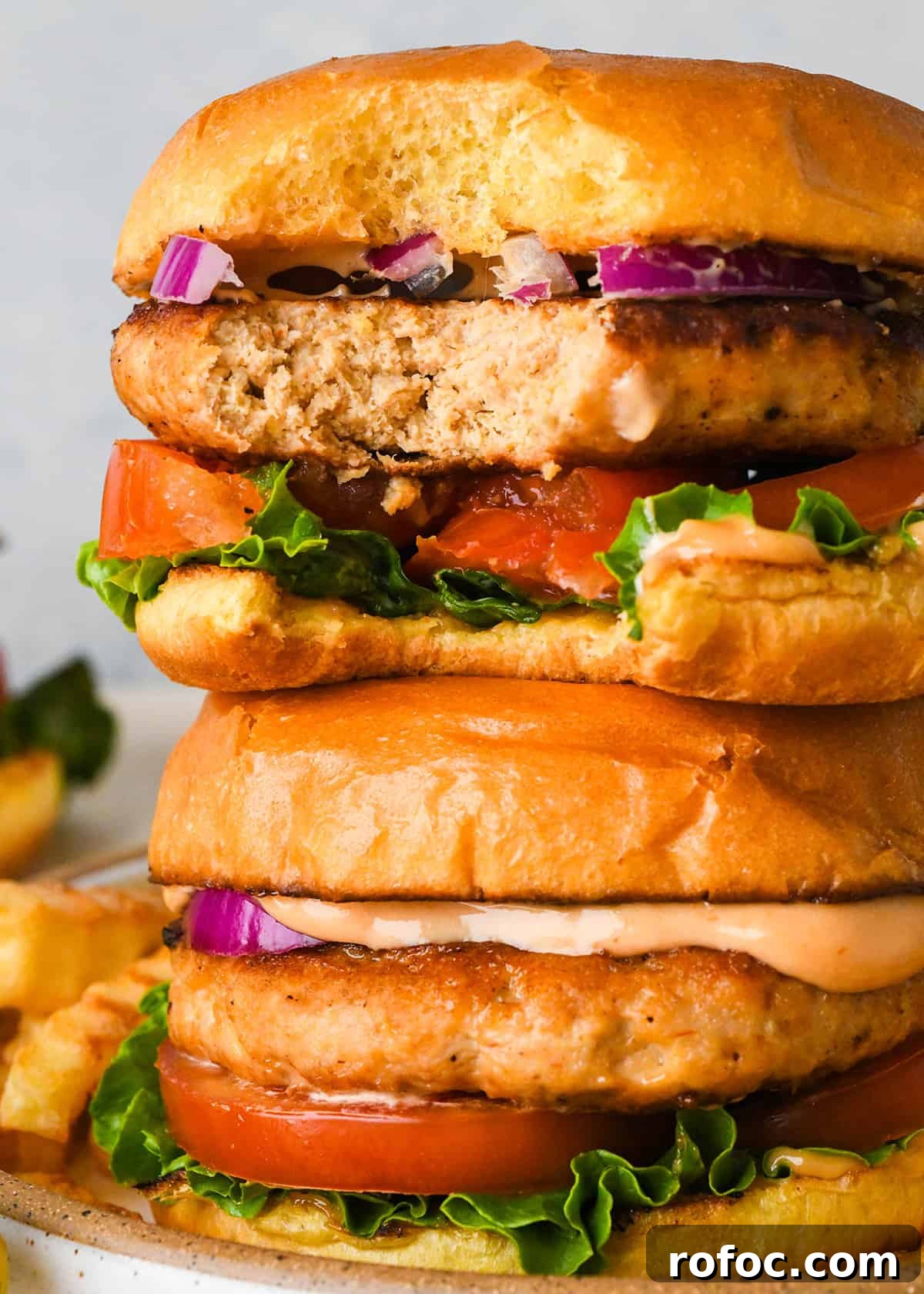 Juicy Turkey Burger Recipes for Flavorful Weeknight Meals 14 a stack of 2 Turkey Burgers, the top one has a bite taken out of it