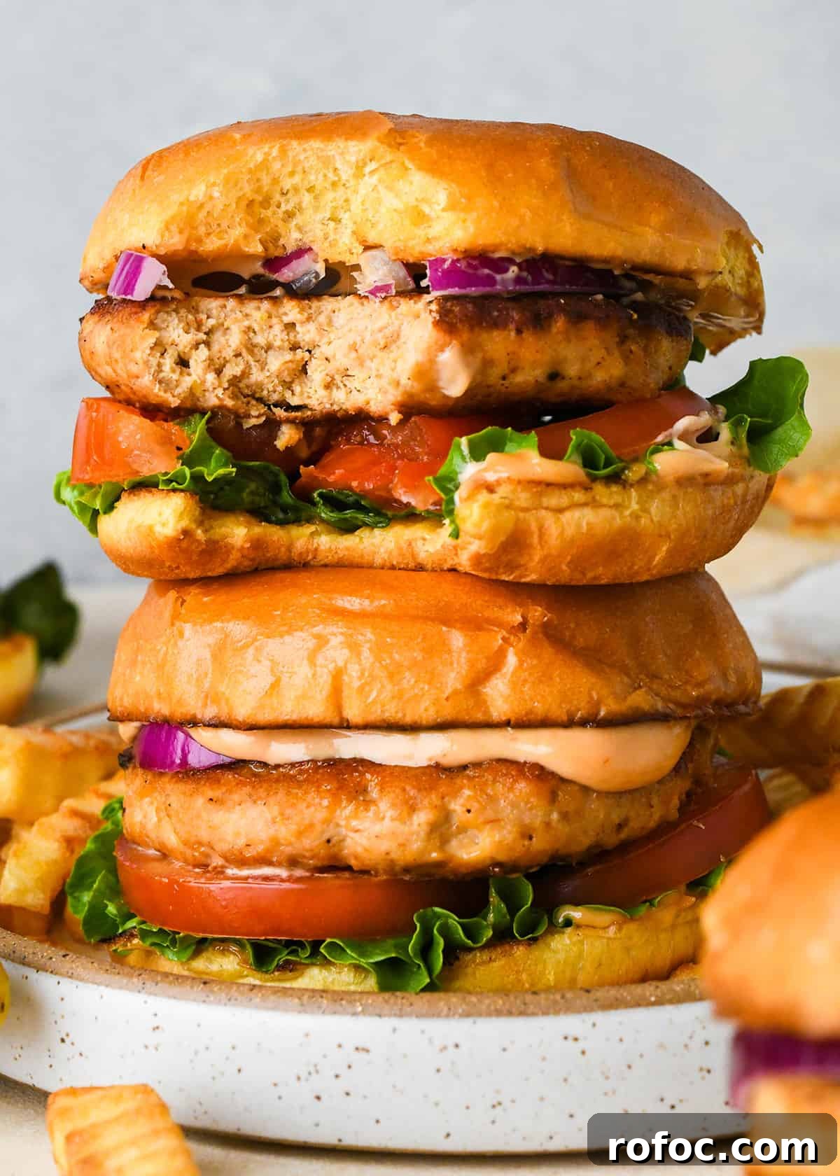 Juicy Turkey Burger Recipes for Flavorful Weeknight Meals 3 a stack of 2 Turkey Burgers on buns, the top one has a bite taken out of it