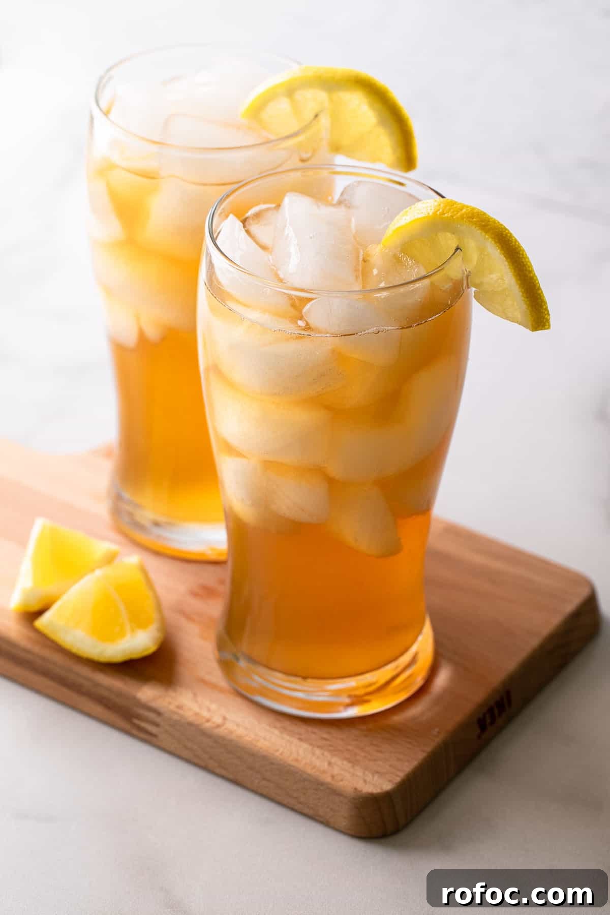 Classic Arnold Palmer Recipe + 3 Refreshing Spiked Variations 2 2 glasses of iced tea with lemon wedges