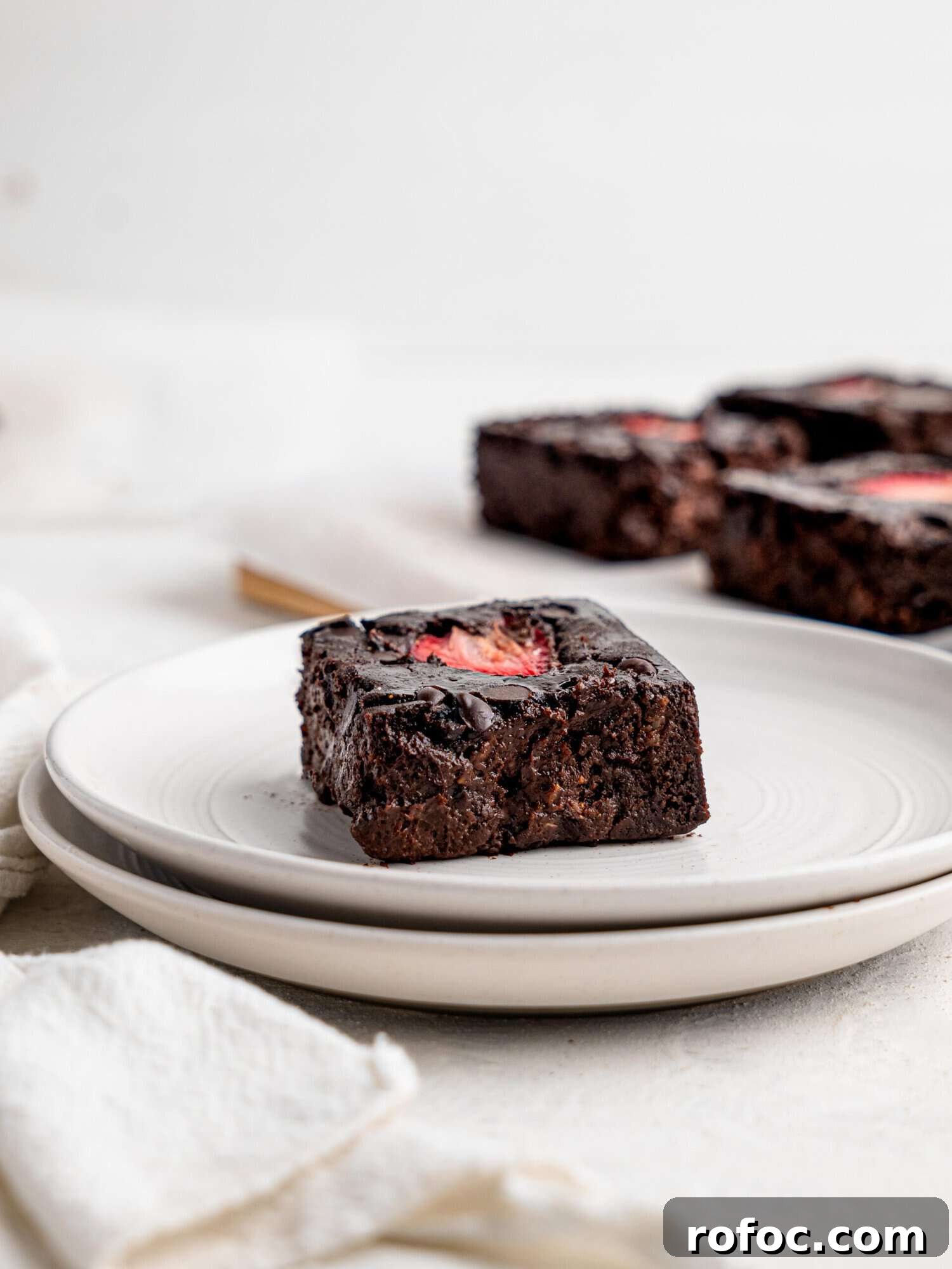 One‑Bowl Strawberry Brownies — Moist, Guilt‑Free Recipe 11 A brownie with strawberry on a white plate.