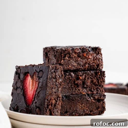 One‑Bowl Strawberry Brownies — Moist, Guilt‑Free Recipe 13 Four brownies with strawberries on a white plate.