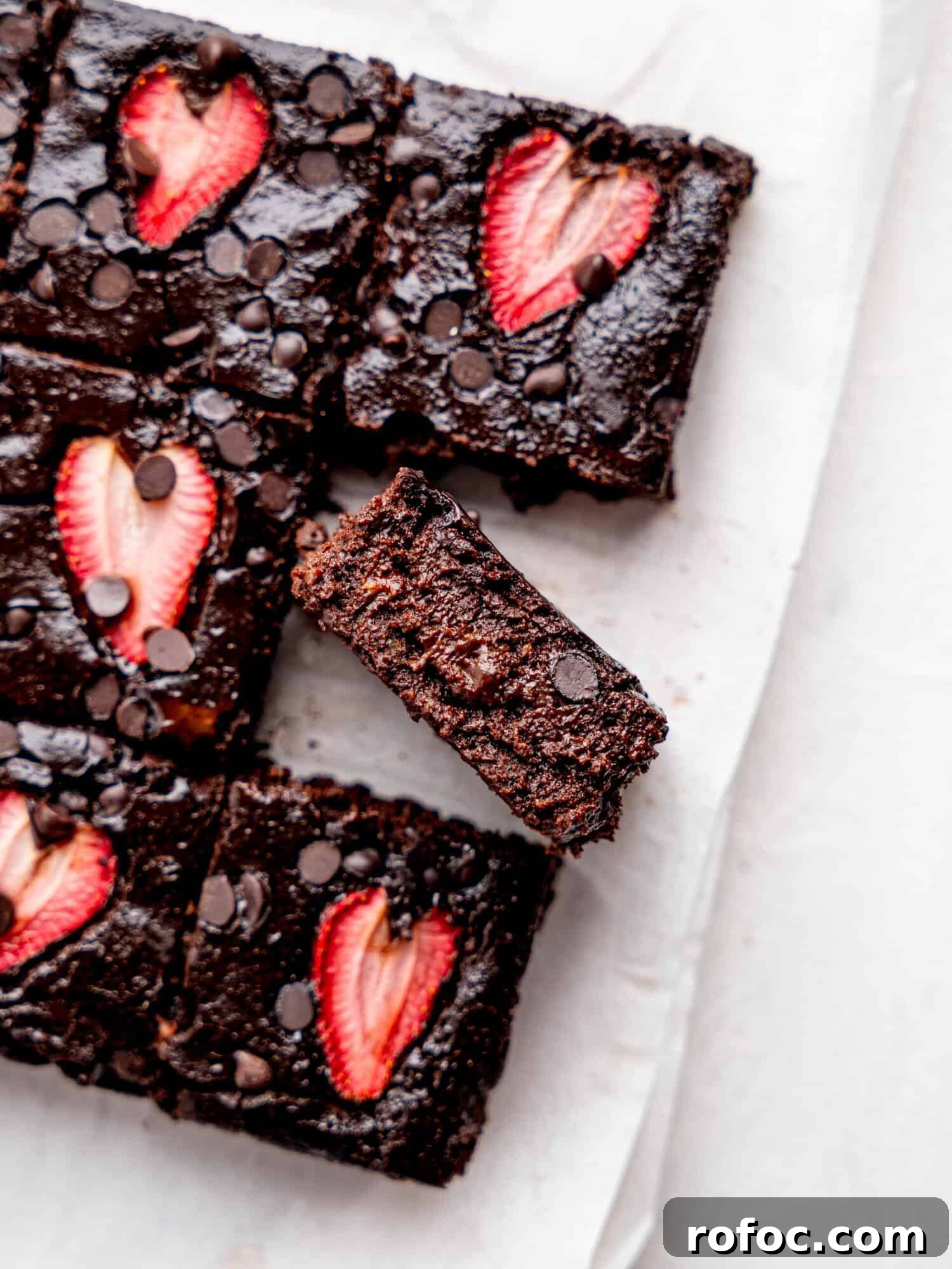 One‑Bowl Strawberry Brownies — Moist, Guilt‑Free Recipe 4 Healthy strawberry brownies on a sheet of parchment paper.