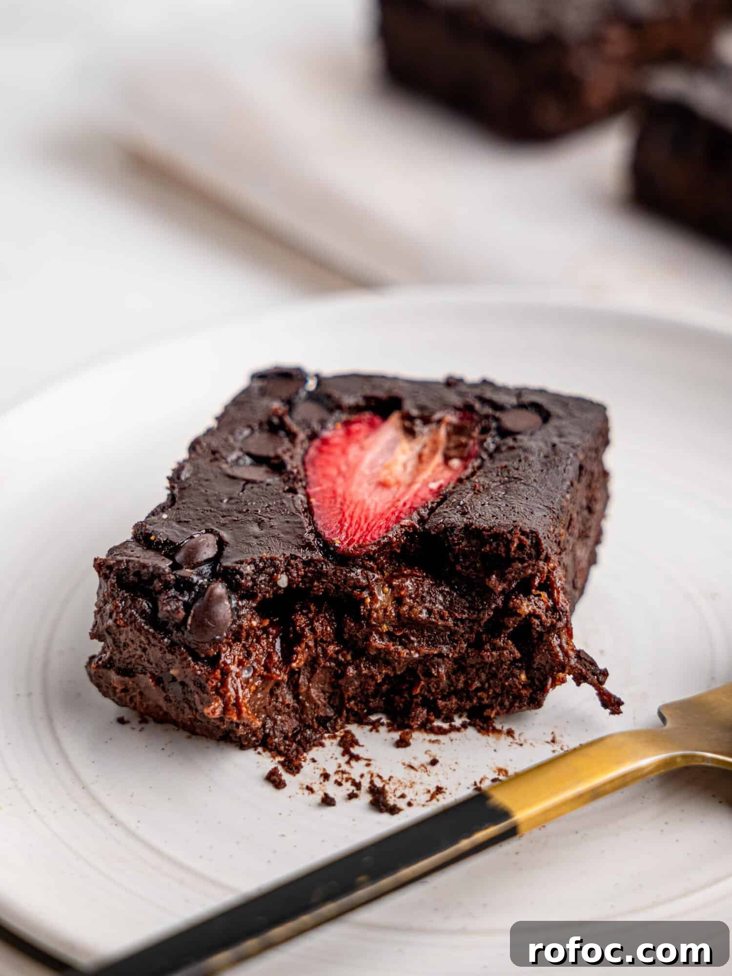 One‑Bowl Strawberry Brownies — Moist, Guilt‑Free Recipe 7 Close up view of a brownie with strawberry.