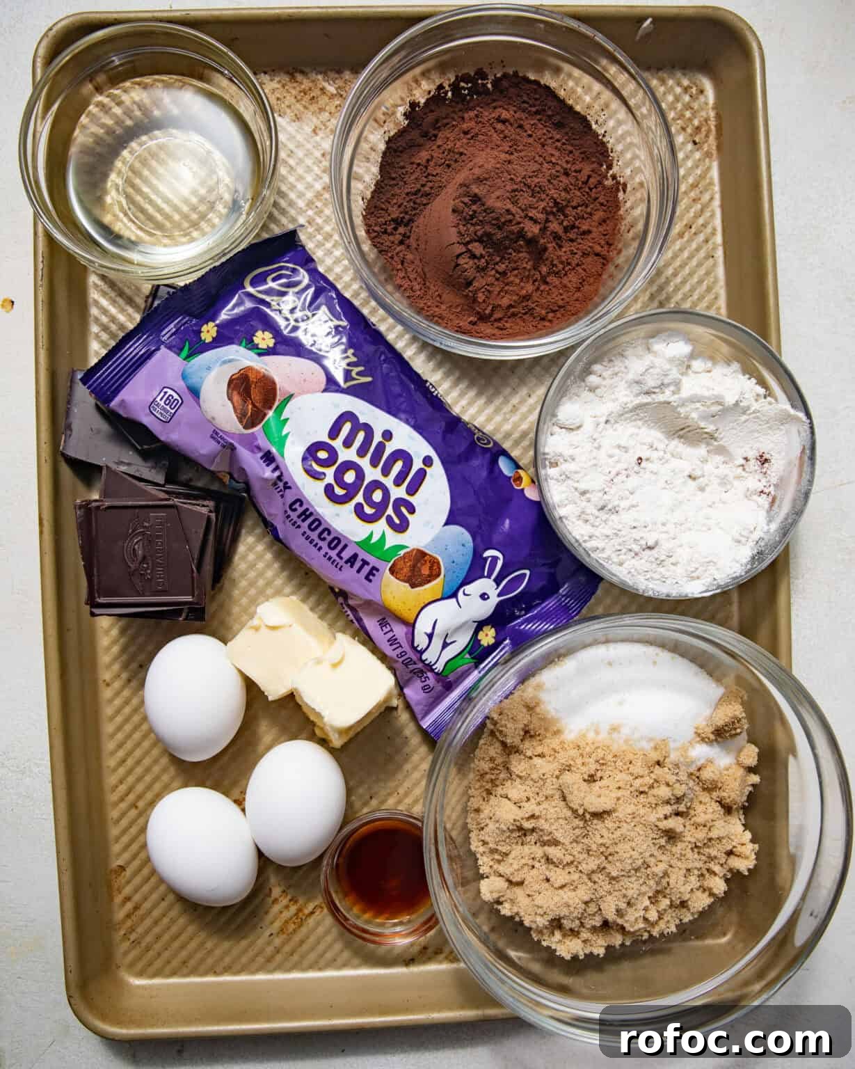 Fudgy Mini Egg Brownies Recipe — Bite-Sized Chocolate Treats 3 ingredients to make cadbury egg brownies on a baking sheet.
