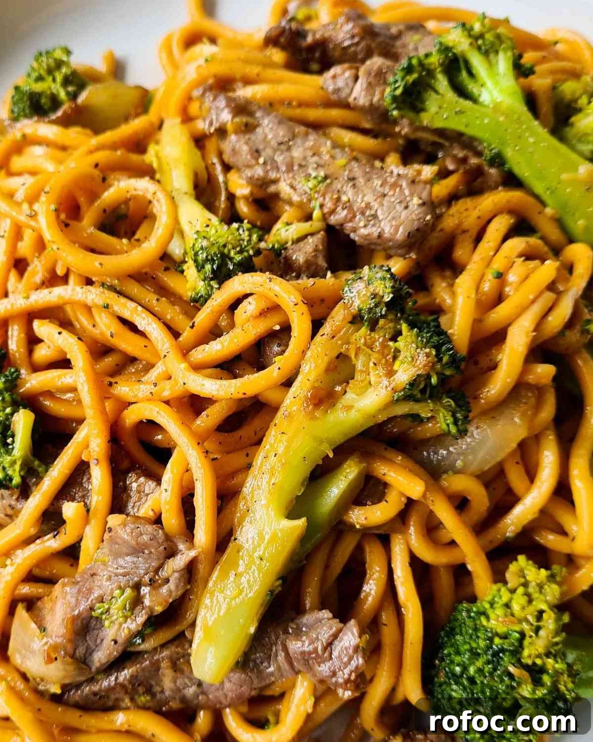 Beef and Broccoli Stir-Fry Noodles Recipe 13 Close up of noodles, broccoli, beef strips and black pepper